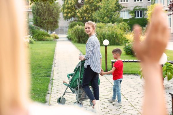 Mother leaving children with teen nanny in park